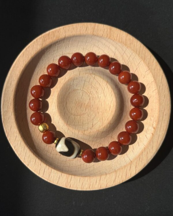 Pray Tai Sui God 2025 Protection Auspicious Light Guardian Bracelet – South Red Agate Tibetan Tiger Eye Dzi Bead Gold Dzambhala Bead on a wood plate